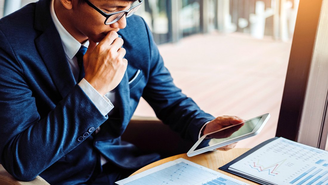 Business owner reviewing financial data and shareholder loan implications on a tablet