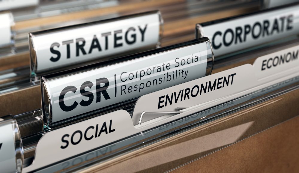 A close-up shot of a file folder cabinet containing several folders labeled "strategy", "CSR: Corporate Social Responsibility", "social", "environment", and "economy".